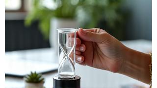 Hand adjusting a desk clock for a quick break, symbolizing efficient stress relief.