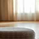 Ergonomic meditation cushion on a wooden floor.